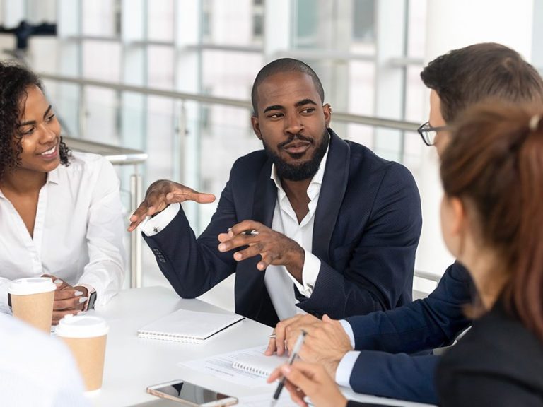 Facilitator talking to three other people about improvement that could be made